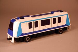 Automated people mover model in white and blue, seen from a front quarter with tinted windscreen, side doors and tires
