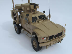 MATV military truck model seen from the front quarter, showing grille, headlights, armored hood and roof gun turret