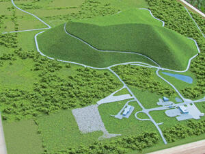 Mill Seat Landfill architectural model close-up of the grassy landfill mound, access roads, pond and small site buildings