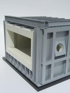 Furnace model corner view with open side revealing cream refractory-lined chamber inside the gray steel frame