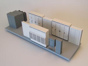 PV skid scale model by KiwiMill with transformer, white inverter cabinets and DC recombiner boxes on a gray base