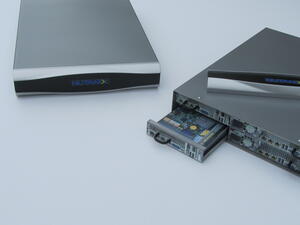 Two server scale models, one showing its curved front bezel, the other its rear with a node drawer pulled out