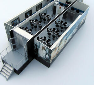 Exhibit trailer model from above, roof off, showing entry deck with stairs, glass doors and two rooms of training tables