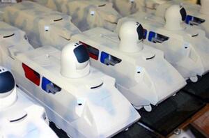 Laser weapon vehicle models lined up in a row, each with a white dome turret and red and blue side panels