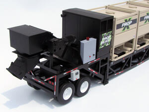Fracking trailer scale model rear view showing black discharge chute, drive motor, control box and tandem wheels
