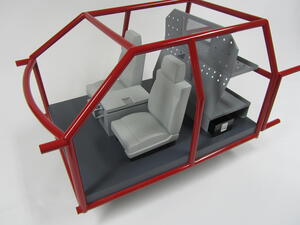 Truck storage model with red tubular cab frame, gray seats, center console and perforated rear storage unit