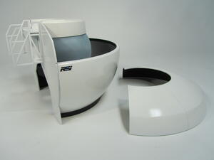Flight simulator scale model with its curved roof section removed, showing the gray cockpit nose inside the dome