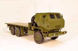 5 Ton Armored Cab MTV truck model in olive drab, front three-quarter view of the armored cab and flatbed