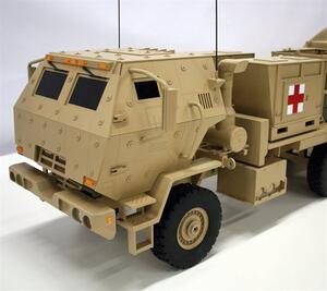 FMTV truck model armored cab close-up with bolt head details, orange marker lights, antennas and red cross container