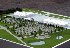 Honda Aircraft Headquarters site model from above, showing white hangars, tree-lined parking lots and two ponds