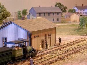 Seneca Falls diorama close-up of the train station with a steam locomotive and figures waiting on the platform