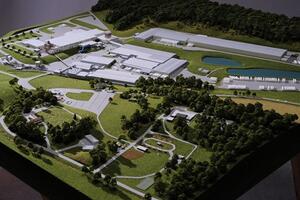 Bush Beans plant site model in a high aerial view, with factory buildings, ponds, wooded hills and landscaped grounds