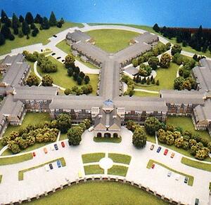 Retirement community architectural model from above, with Y-shaped wings, entry portico, trees and front parking lots