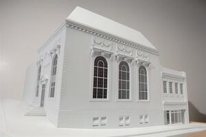 White architectural model of a neoclassical building with arched windows, cornice and corner entry steps
