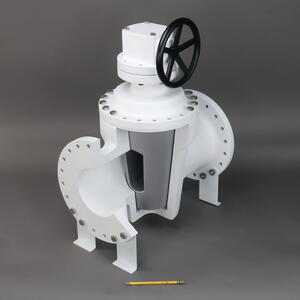 Plug valve training model by KiwiMill in cutaway view, gray tapered plug exposed, with a pencil for scale