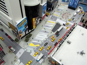 Times Square scale model seen from above with yellow taxis, crosswalks, painted plazas and billboard towers