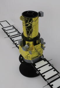 Satellite scale model from above, showing the gold foil telescope tube, open aperture and sensors on the hexagonal bus