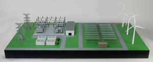 Renewable energy scale model with transmission towers, substation, battery skids, solar field and three wind turbines