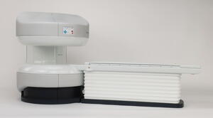 Open MRI scale model at 1/4 scale in side view, with the patient table docked against the magnet gantry