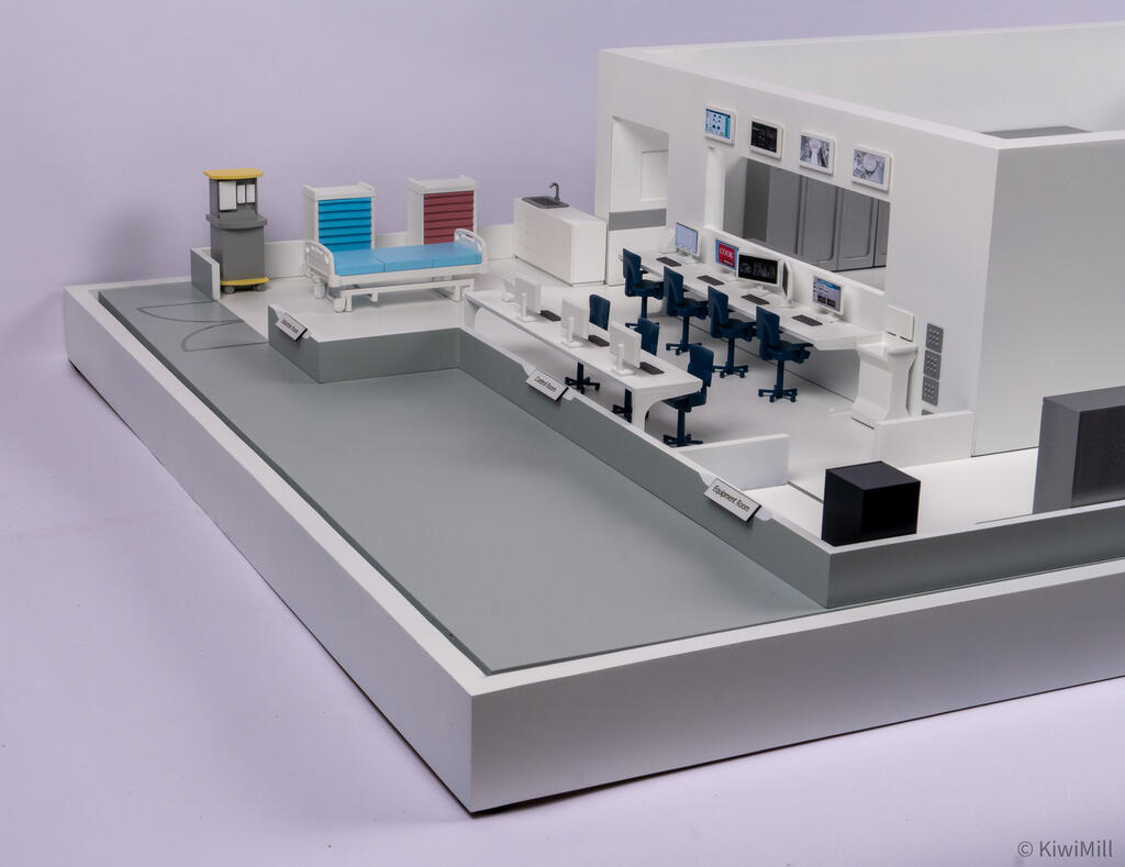 Low corner view of the induction, control and equipment room areas with their labels along the base edge