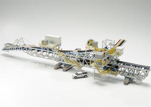 Mobile stacking conveyor model at 1:75 scale, full side view with crawler tracks, truss frame and pickup truck for scale
