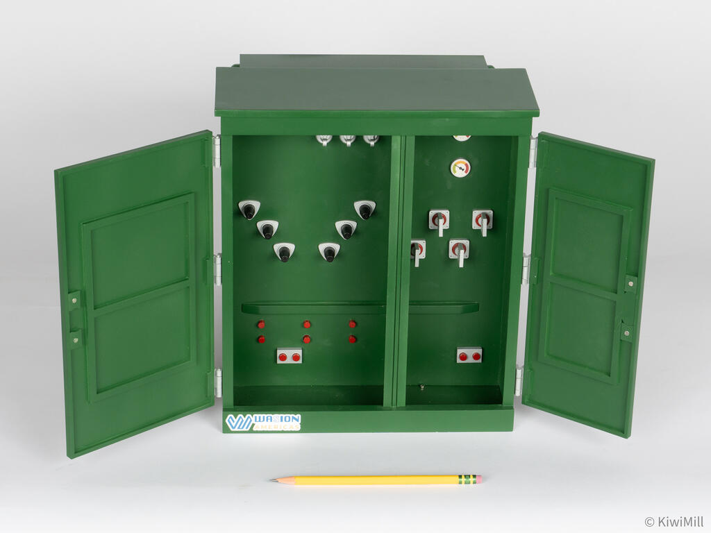 Transformer model with both cabinet doors open, showing bushings, gauges and switches, pencil in front for scale