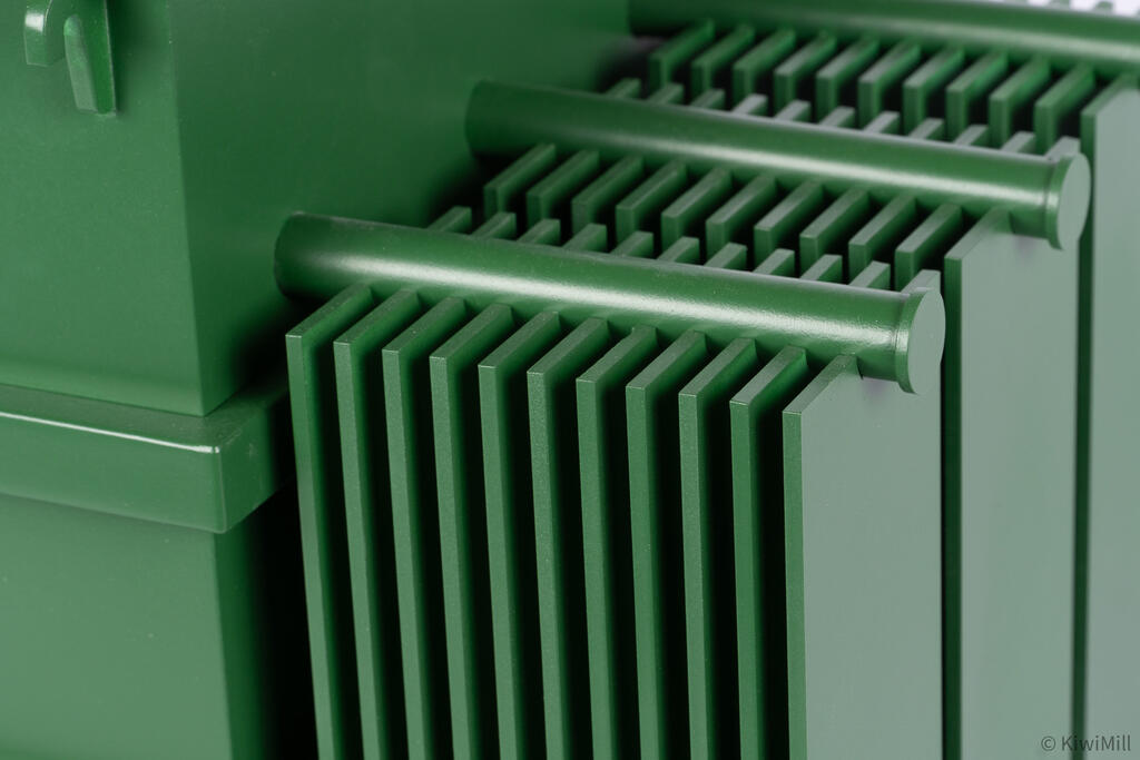 Close-up of radiator banks on the transformer model, with header pipes running across thin vertical cooling fins