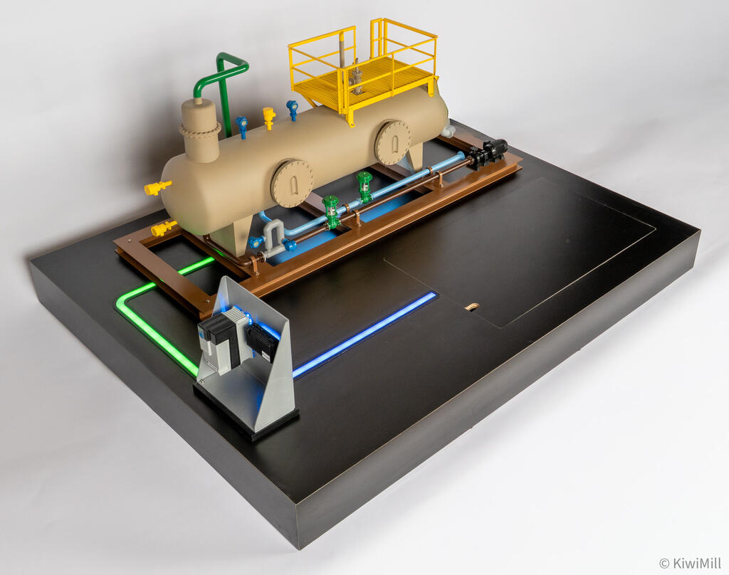 Separator skid model from high angle, green and blue light paths running from gray device stand across the black base
