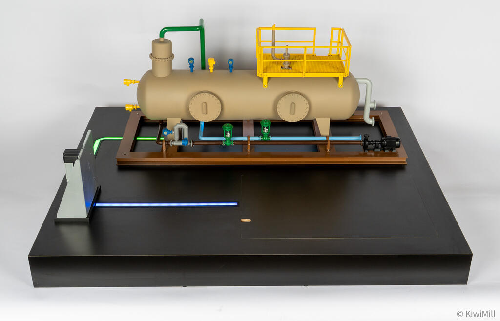 Elevated front view of the separator skid model with green control valves on light blue piping and lit base paths