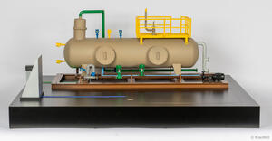 Separator skid scale model front view, horizontal vessel with yellow platform on brown frame atop a black display base