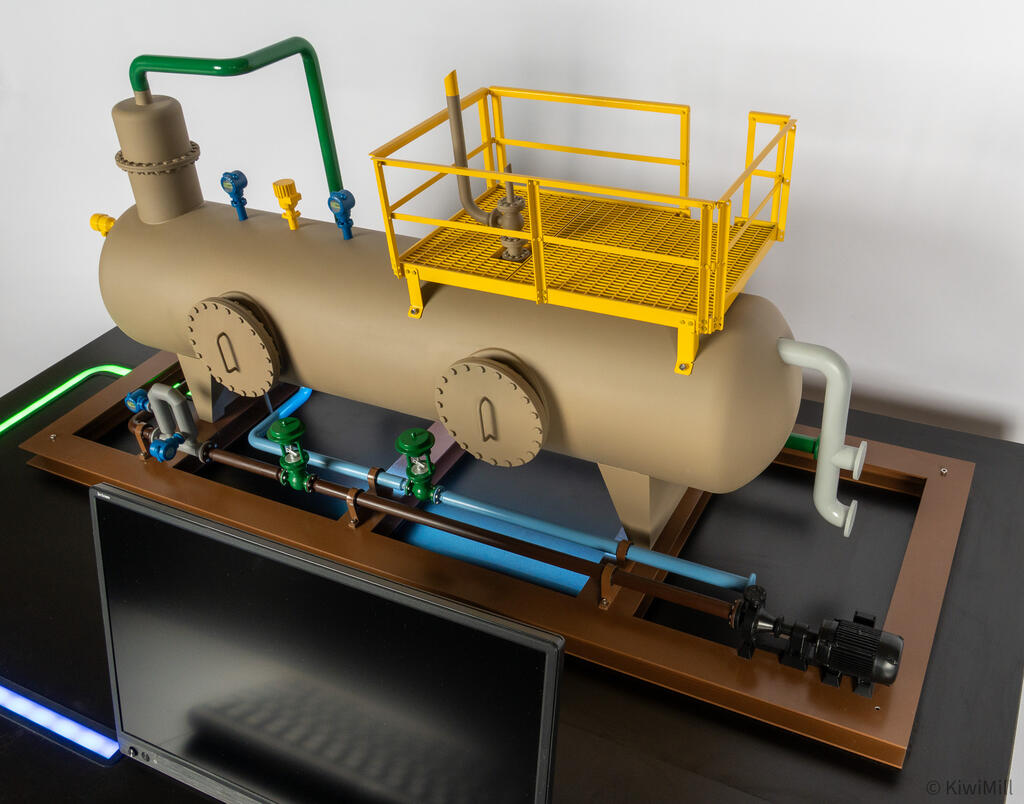 Close-up of the separator skid's yellow grated access platform, bolted manway covers and pump at the end of the frame