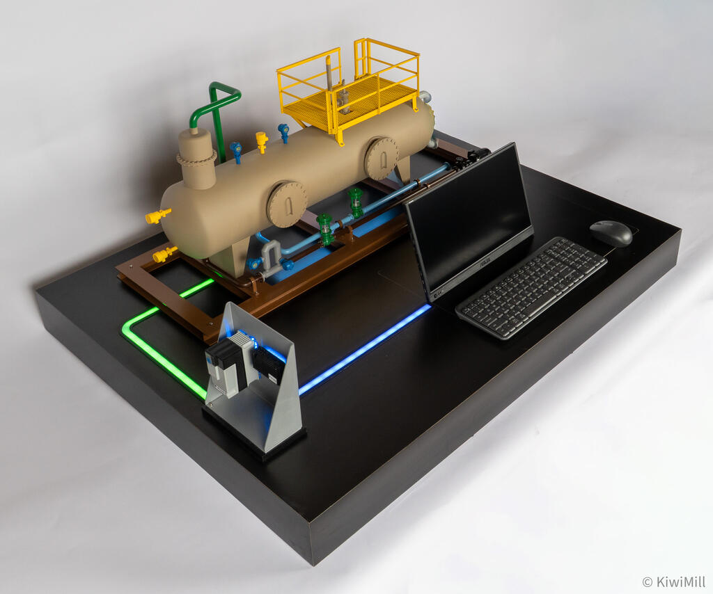 Separator skid model with monitor, keyboard and mouse on the base, green and blue light paths leading to the computer