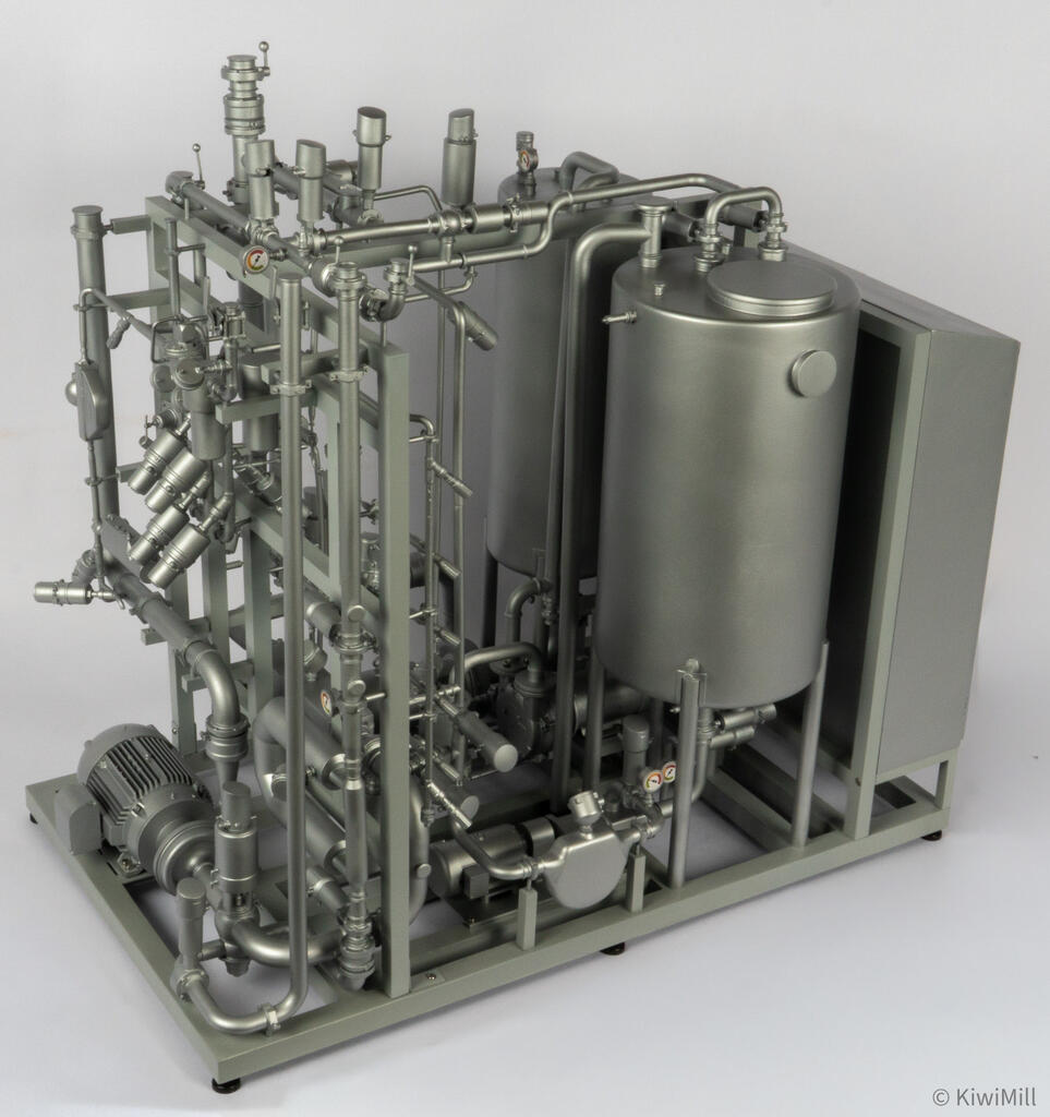 Elevated three-quarter view of the open skid with angled actuator banks, both tanks and enclosure at the far end