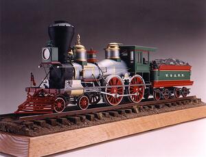 The General steam locomotive scale model with tender, three-quarter front view on a ballasted track and wood base